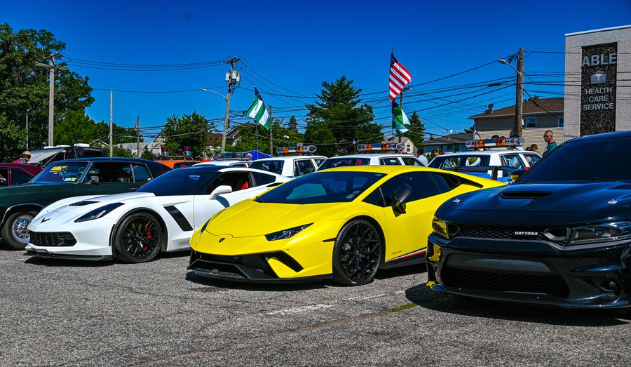Lineup of supercars under summer flags
