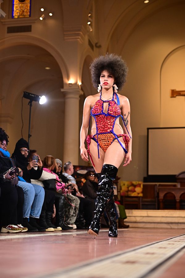 Model in a bold printed look walking the runway