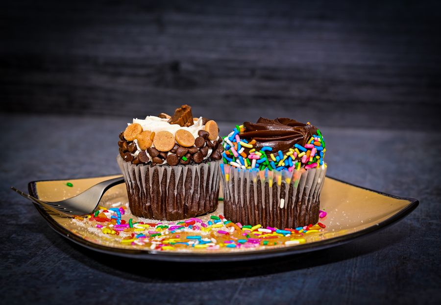 Cupcakes with sprinkles on a rustic table