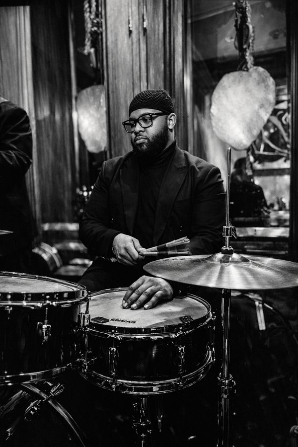 Black and white photograph of a drummer mid-set